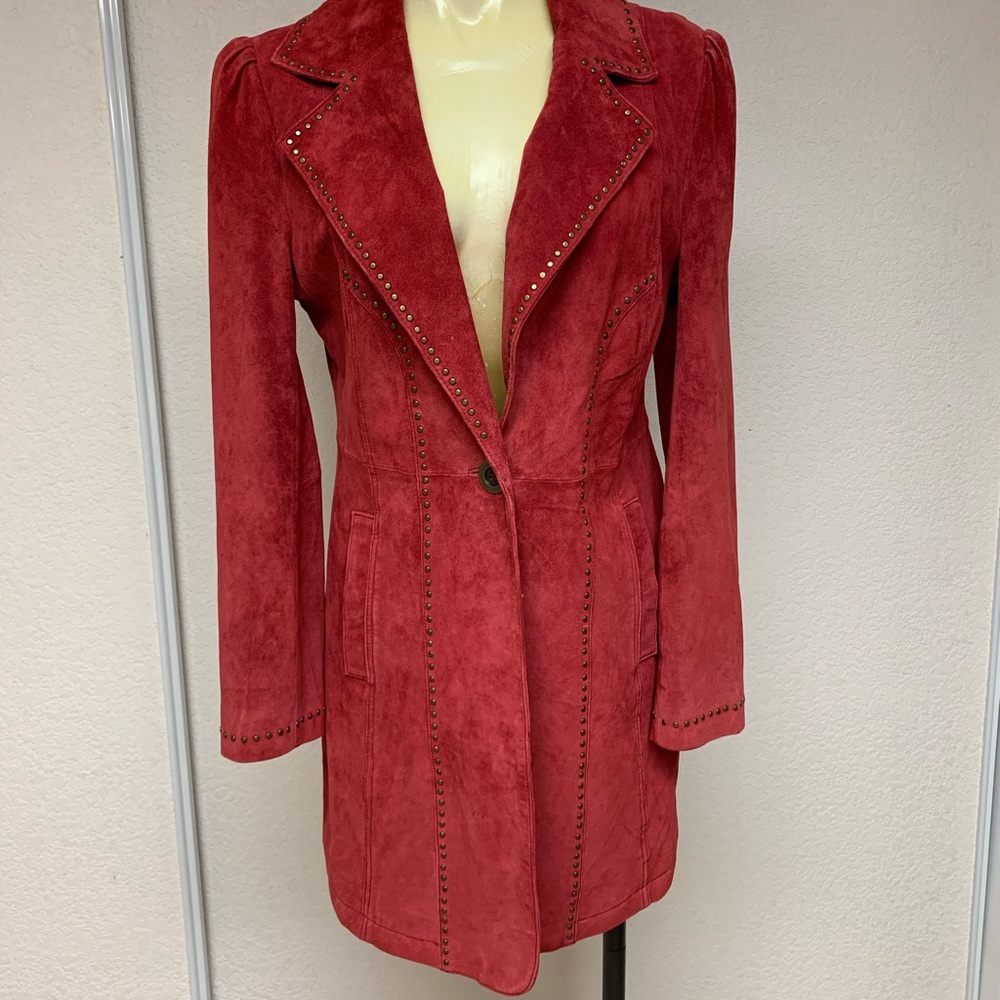 In Suede Jacket with grommet detailing. One button closure front with pockets.